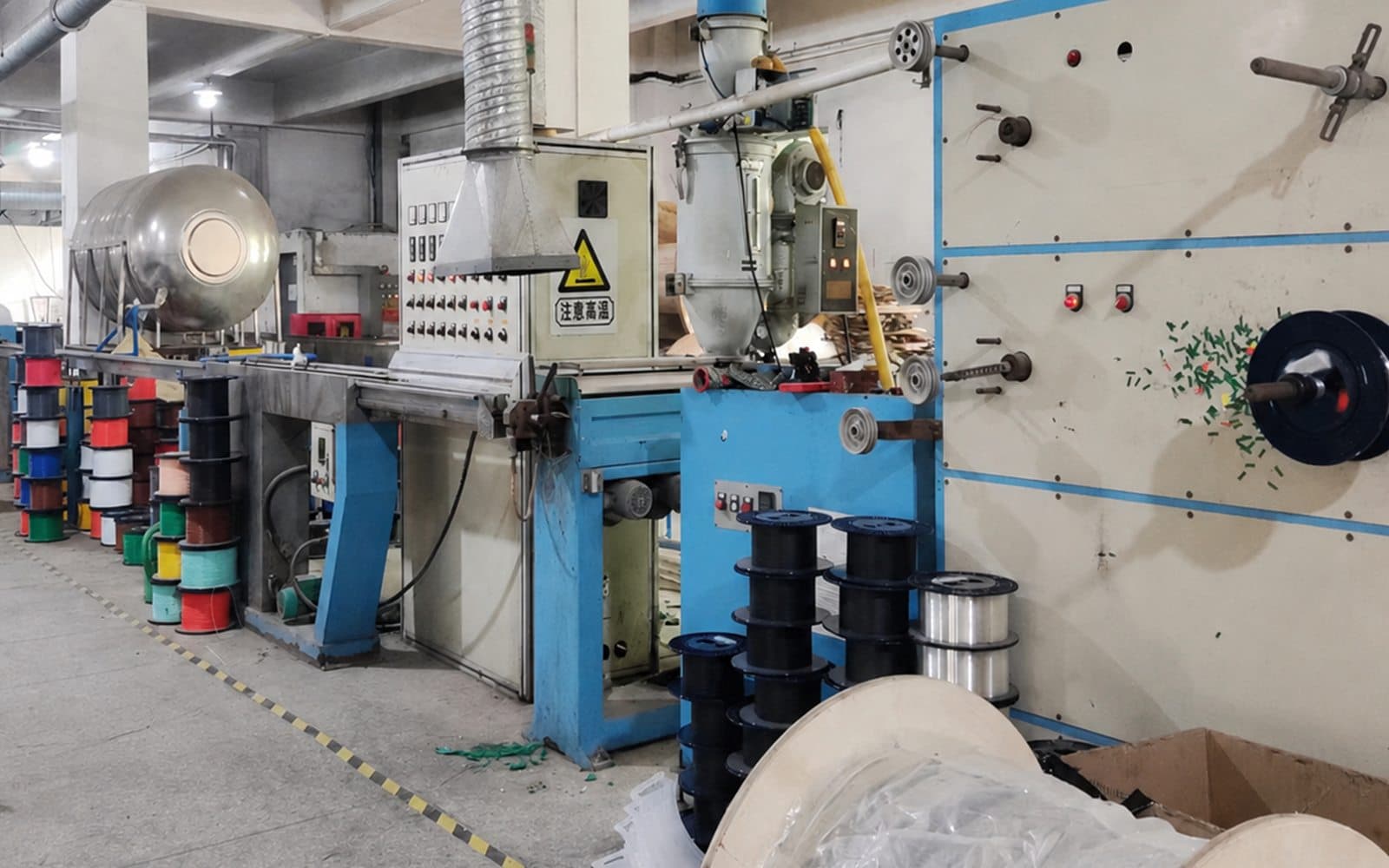 Fiber optic cable production equipment and colored process reels in the factory